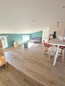 a living room with a table and a couch at Studio cosy in Burlats