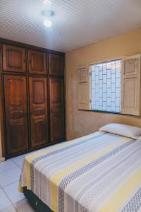 a bedroom with two beds and a window at Casa Celeste in Boa Vista +6 photos