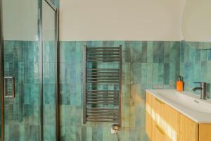 a bathroom with a shower and a sink at La Canopée - Bohemian - chic apartment in Lens