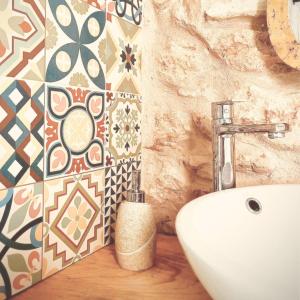 a bathroom with a sink and a wall with tiles at Escapada rural en Nulles, cerca de Tarragona in Nulles +29 photos
