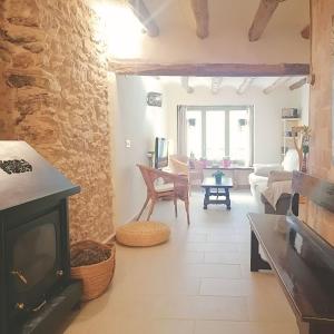 a living room with a fireplace and a couch at Escapada rural en Nulles, cerca de Tarragona in Nulles