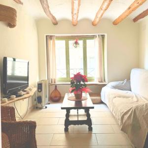 a living room with a couch and a table at Escapada rural en Nulles, cerca de Tarragona in Nulles