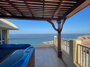 a balcony with a view of the ocean at Prime Plaza Porto Towers Stay Hotel VIP in Ain Sokhna