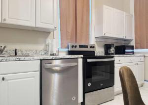 a kitchen with white cabinets and a stainless steel oven at The Harrison Apartments in Evansville