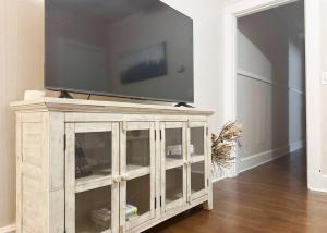 a wooden entertainment center with a television on top of it at The Harrison Apartments in Evansville