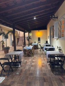 a patio with tables and chairs in a building at Pousada de Bonito in Bonito
