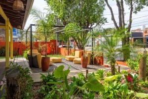 a garden with couches and trees and plants at Pousada de Bonito in Bonito