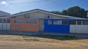 a building with a blue and orange garage at Casa Celeste in Boa Vista