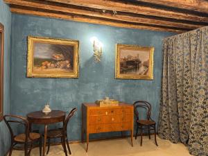 a dining room with a table and chairs and a painting at NEW OPENING San Marco Secret 4343 in Venice +116 photos