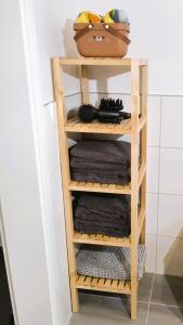 a wooden shelf in a bathroom with towels at FeWo D&Y -barrierefrei- in Ubstadt-Weiher +53 photos