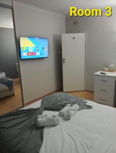 a bedroom with a bed with a tv on the wall at Kliprivier Accommodation in Johannesburg +79 photos