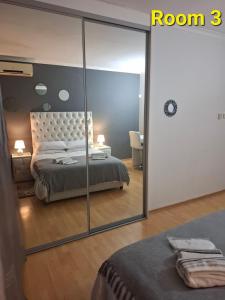 a bedroom with a bed and a large mirror at Kliprivier Accommodation in Johannesburg