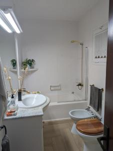 a bathroom with a toilet and a sink and a tub at La mejor terraza de Tamariu in Tamariu +36 photos