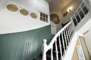 a staircase in a house with a basketball on the wall at Hotel Le Coureau in Saint-Trojan-les-Bains