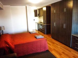 a bedroom with a bed and a refrigerator at Spinifex Hotel in Derby