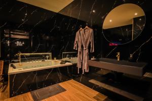 a bathroom with a tub and a sink and a mirror at Golden Suite - Elegance - Private Spa Jacuzzi in Lens