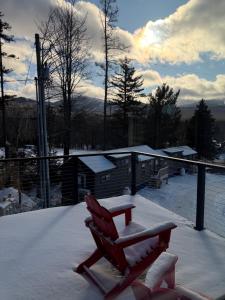 a snowcovered chair on a deck with a snow covered at The Carriage House at Boulder Mountain View in Carroll