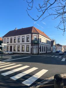 a large white building on a street with a crosswalk at Homeday joffre 3 type f2 in Haguenau