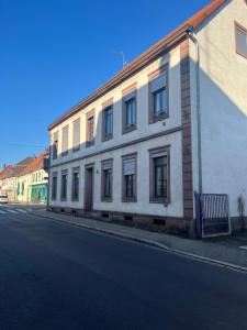 a white building on the side of a street at Homeday joffre 3 type f2 in Haguenau