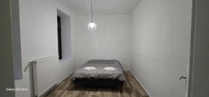 a small room with a small bed in the corner at Homeday joffre 3 type f2 in Haguenau