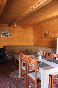 a dining room with a table and chairs at Mountain House Jelovica in Berane