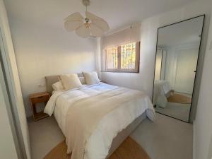 a white bedroom with a bed and a mirror at ALTEA LUXURY - Blue Pearl in Altea la Vieja +61 photos