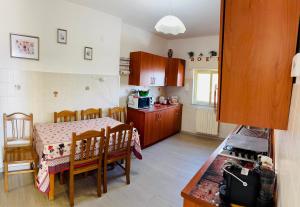 a kitchen with a table and chairs and a kitchen with a table and a kitchen at Casa tua a Pergusa in Pergusa +6 photos