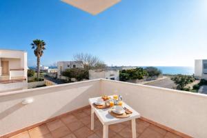 a table on a balcony with a view of the ocean at ONDA BLU-Appartamenti in Torre dell'Orso