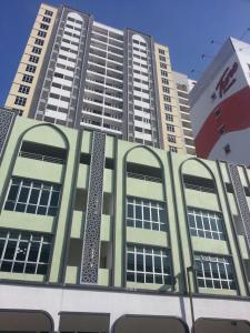 a tall building with windows on the side of it at Homestay KBCC in Kota Bharu