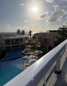 a view from the balcony of a resort with a swimming pool at Apartamento Duplex vista mar Buzios in Nísia Floresta