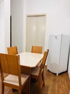 a kitchen with a table and chairs and a refrigerator at Apto RUA DO LAZER in Santa Teresa