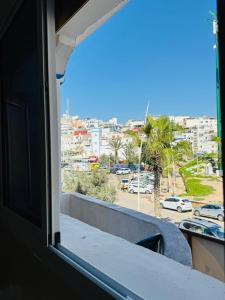 a window view of a city from a balcony at Vitamin taliouine appartement in Taghazout