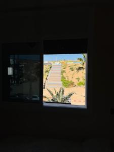 a window in a room with a view of a stairway at Vitamin taliouine appartement in Taghazout
