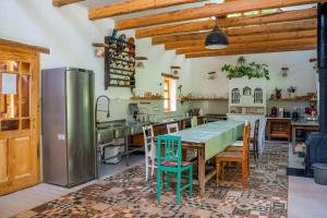 a large kitchen with a table and chairs at NohaTerény in Terény