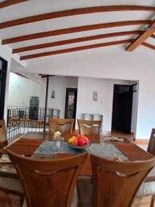 a dining room with a wooden table and chairs at Casa Fabiana in Lemos +24 photos