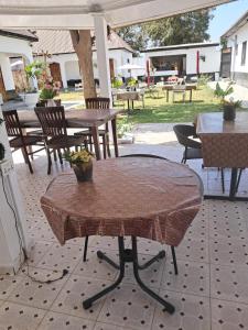 a brick table and chairs on a patio at Maria's place in Tujering +13 photos