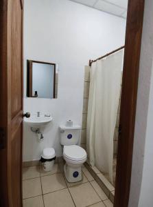 a bathroom with a toilet and a sink at Hostal Jireh in Altagracia