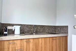a kitchen with a sink and a counter top at Santirome Studio 2 - Cozy Westpunt Escape for Two in Westpunt