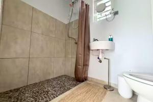 a bathroom with a shower and a toilet and a sink at Santirome Studio 2 - Cozy Westpunt Escape for Two in Westpunt