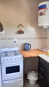 a kitchen with a white stove and a counter at Altos de la Villa House in Concepción del Uruguay