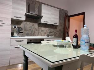 a kitchen counter with a bottle of wine and a bowl of food at Casa Mami' in Marigliano