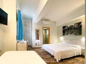 a hotel room with two beds and a mirror at Te Maná Hotel in Torreblanca
