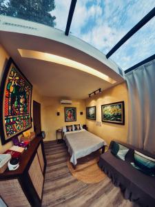 a bedroom with a bed and a couch in a room at abot langit calatagan in Calatagan