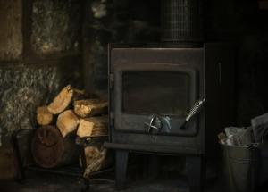 an old tv sitting next to a pile of wood at Devlin's Cottage in Cape Bridgewater