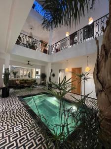 a house with a swimming pool in a courtyard at Riad OUAR - Once Upon A Riad in Marrakesh