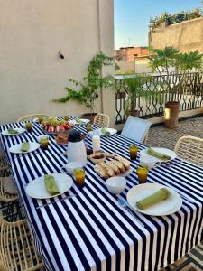 a blue and white striped table with food on it at Riad OUAR - Once Upon A Riad in Marrakesh