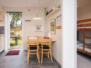 a kitchen and dining room with a table and chairs at 6 person holiday home in Rømø-By Traum in Sønderby