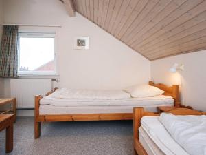 two twin beds in a room with a window at 6 person holiday home in Rømø-By Traum in Sønderby +41 photos