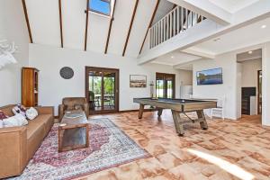 a living room with a pool table and a couch at Standen Manor, Hunter Valley Country Estate & Stables in Belford