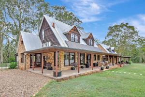 a large house with a gambrel roof at Standen Manor, Hunter Valley Country Estate & Stables in Belford